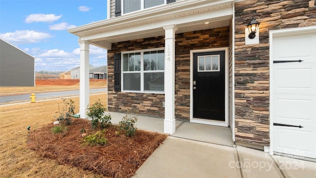 view of exterior entry with covered porch