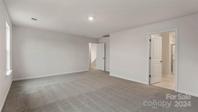 unfurnished bedroom with light carpet