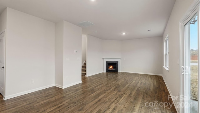 unfurnished living room featuring dark wood-type flooring