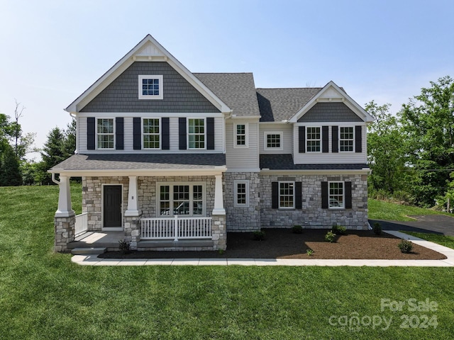 craftsman house with a front lawn and a porch