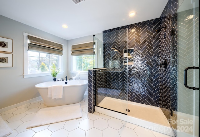 bathroom featuring tile patterned flooring and plus walk in shower