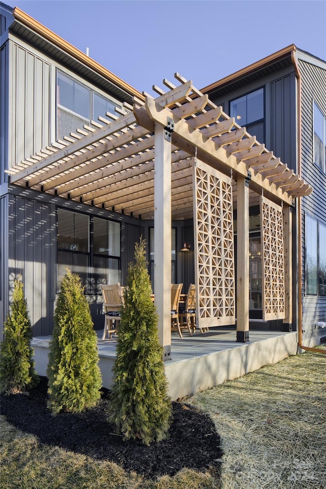 view of side of property featuring a pergola and a patio area