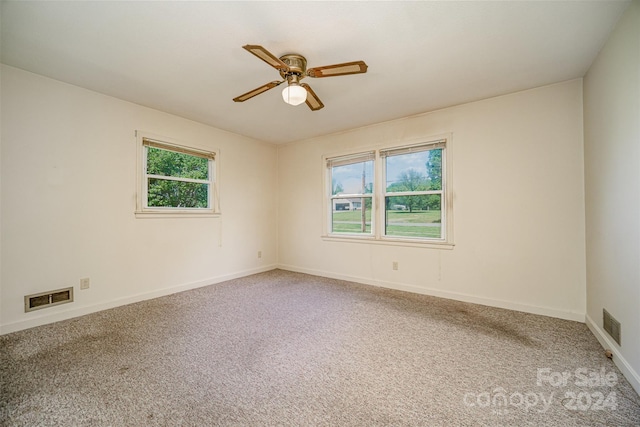 empty room with ceiling fan, carpet floors, and a healthy amount of sunlight