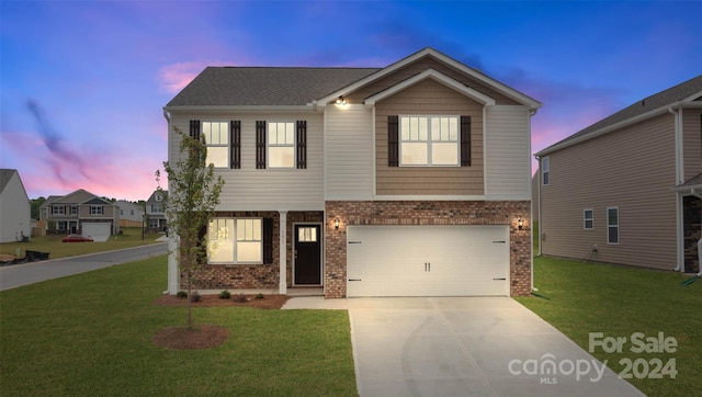 view of front of home featuring a yard and a garage