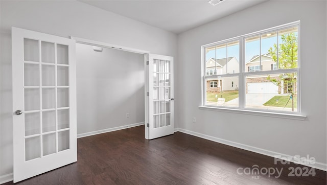 empty room with french doors and dark wood-type flooring