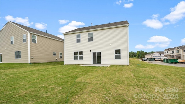 back of house with a yard and a patio