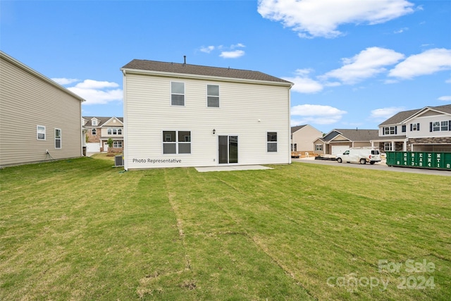 rear view of house with a yard