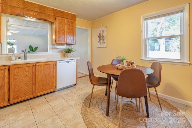 kitchen with dishwasher, light tile patterned flooring, and sink