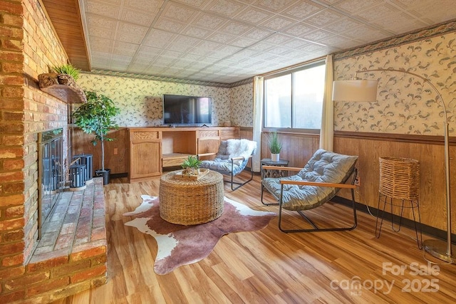 living area with a fireplace and light hardwood / wood-style floors