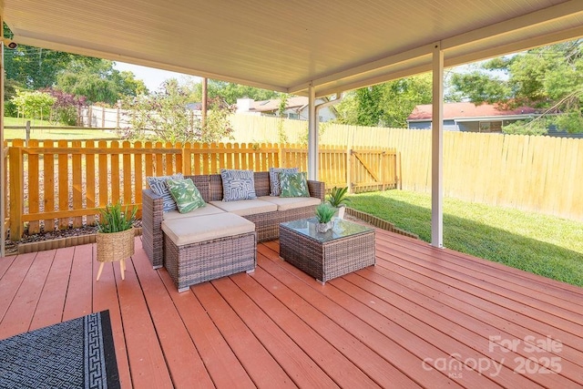 wooden terrace featuring outdoor lounge area and a lawn