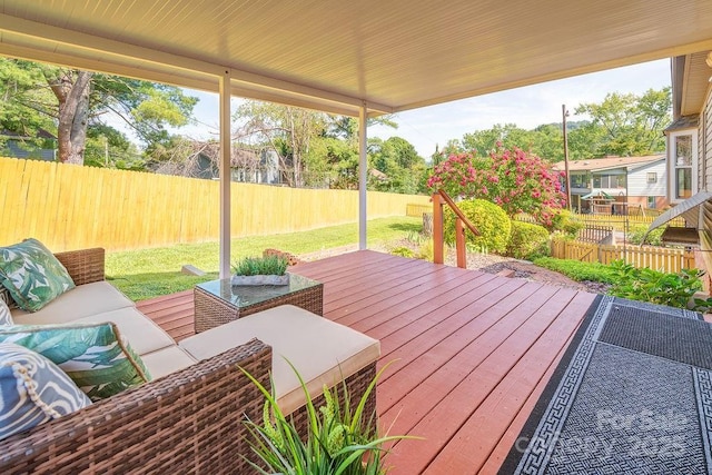 wooden deck featuring a yard