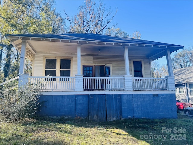 back of property with a porch