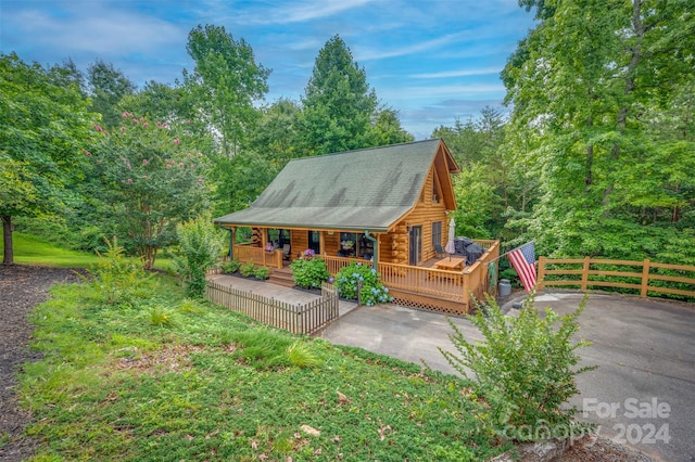 back of property featuring covered porch