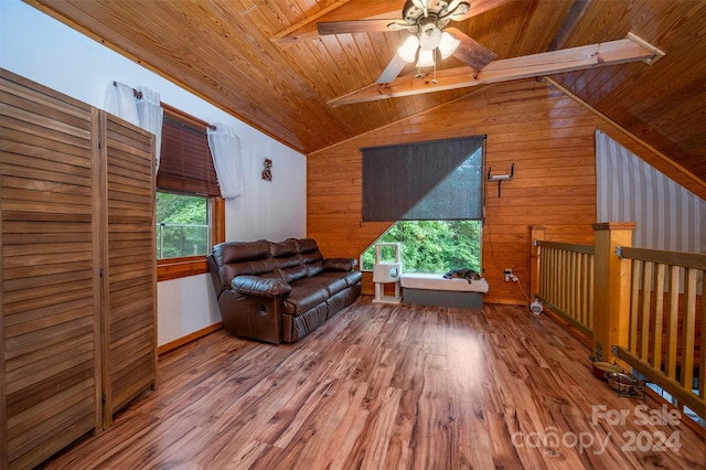 sitting room with vaulted ceiling with beams, hardwood / wood-style flooring, wooden walls, and wooden ceiling