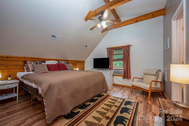 bedroom featuring ceiling fan, vaulted ceiling with beams, cooling unit, and light hardwood / wood-style floors