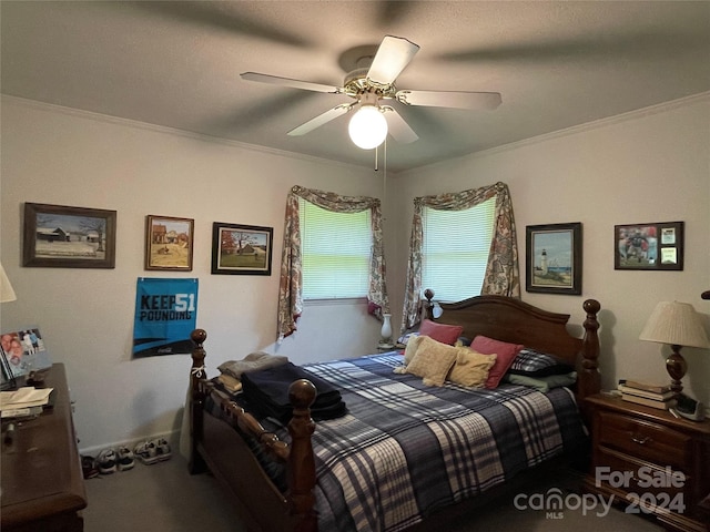 carpeted bedroom with ceiling fan and ornamental molding