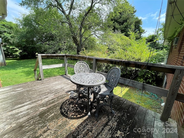 wooden deck with a lawn