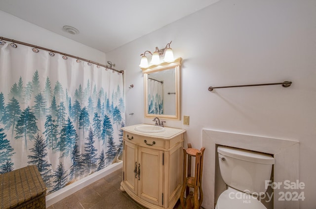 bathroom with toilet, vanity, and a shower with shower curtain