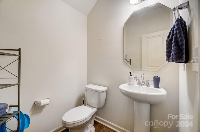 bathroom with toilet and lofted ceiling