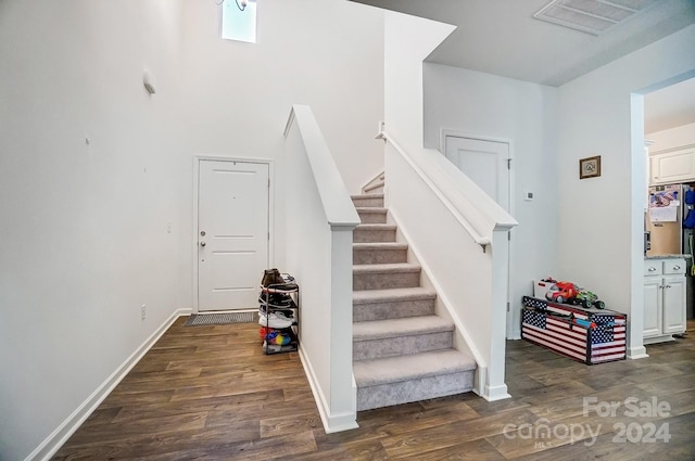 stairs with hardwood / wood-style floors