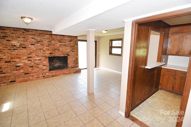 unfurnished living room featuring a textured ceiling, light tile patterned floors, and a fireplace