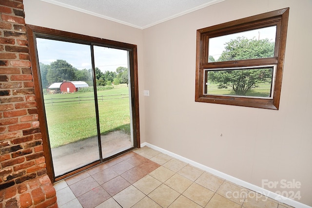 doorway to outside with a textured ceiling, light tile patterned floors, and ornamental molding