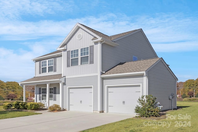 view of front of house featuring a front yard and a garage