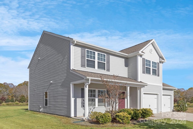 view of front facade featuring a garage and a front lawn