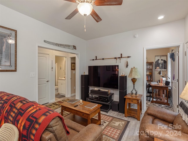 living room with ceiling fan and light wood-type flooring