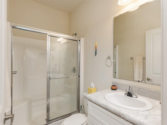 bathroom featuring walk in shower, vanity, and toilet