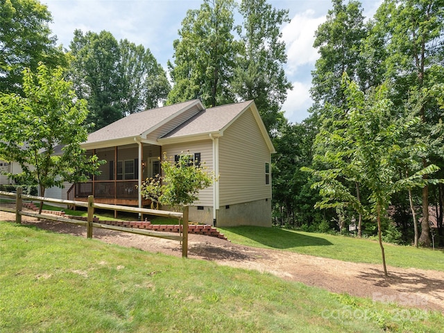 exterior space featuring a lawn and a sunroom