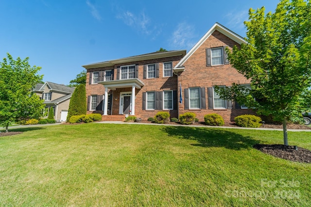 colonial-style house with a front lawn