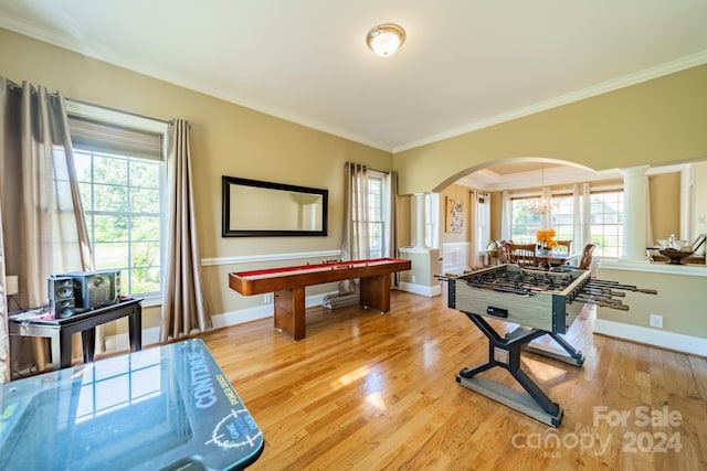 recreation room with a chandelier, wood-type flooring, and crown molding