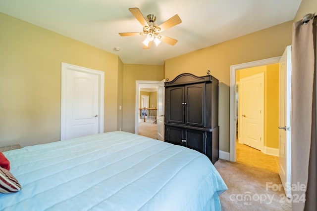 carpeted bedroom with ceiling fan and a closet