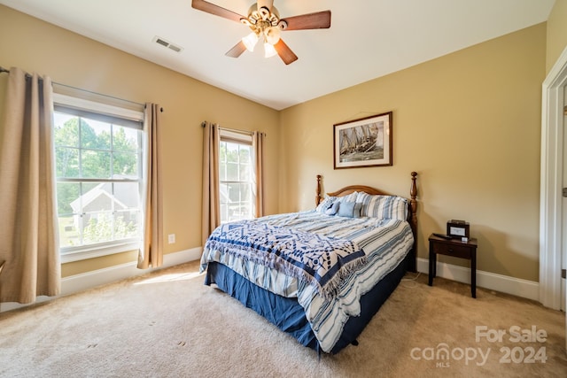 carpeted bedroom with ceiling fan