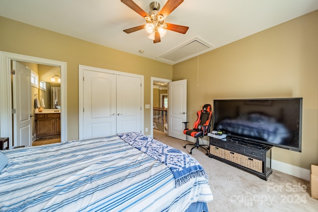 carpeted bedroom featuring ceiling fan, ensuite bathroom, and a closet