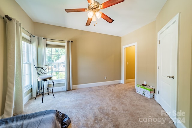 sitting room featuring ceiling fan and light colored carpet