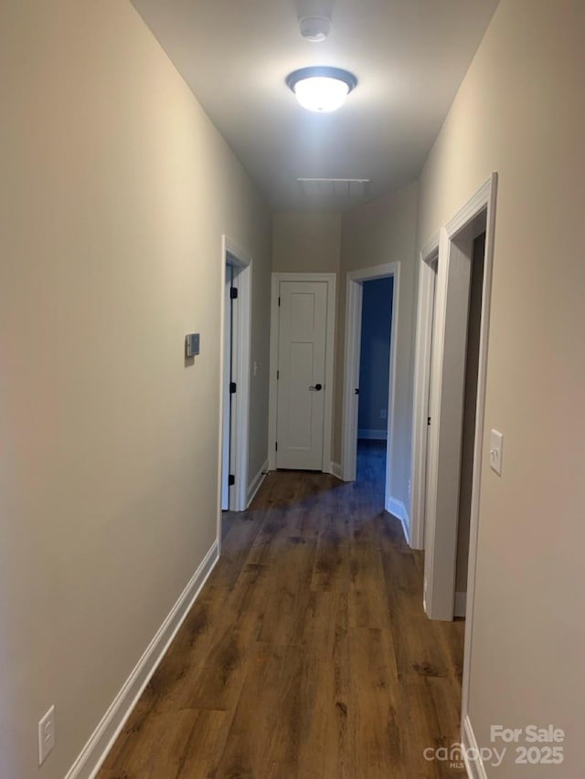 corridor featuring dark hardwood / wood-style floors