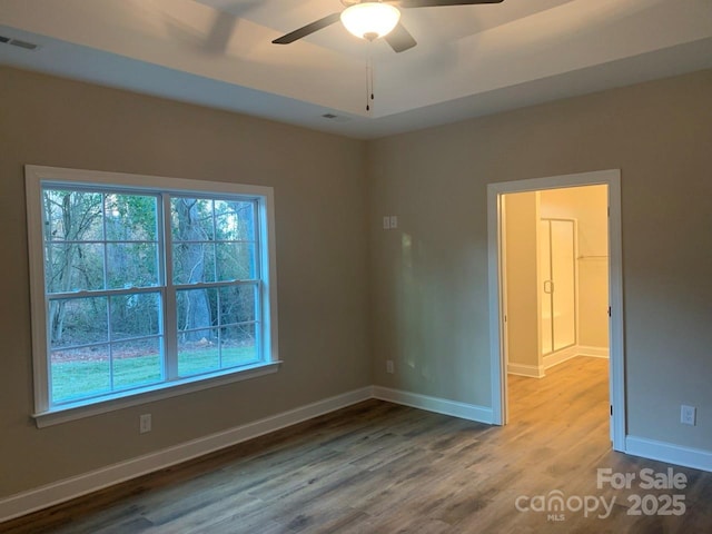 unfurnished room with ceiling fan and hardwood / wood-style flooring