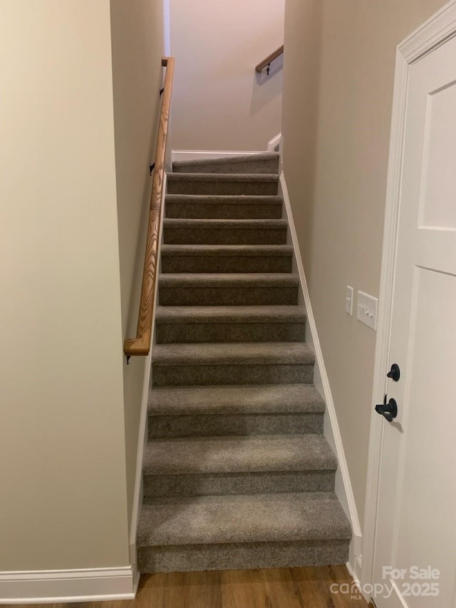 stairs featuring wood-type flooring