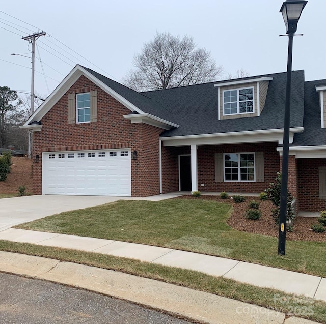 view of front of home featuring a porch, a front yard, and a garage