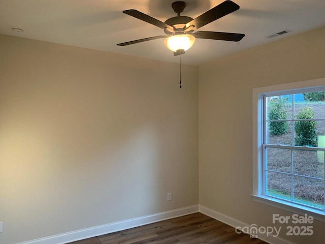 empty room featuring ceiling fan and dark wood-type flooring