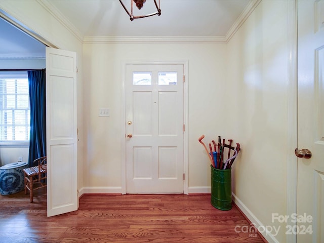 foyer featuring hardwood / wood-style floors and crown molding