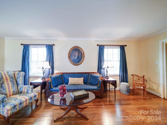 living room featuring hardwood / wood-style flooring, crown molding, and a wealth of natural light