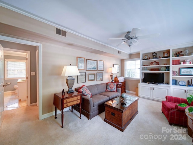 carpeted living room featuring ceiling fan