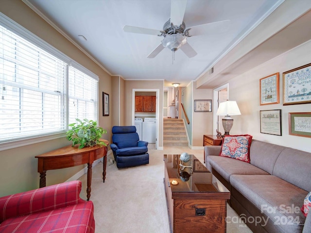 living room featuring carpet, washer and dryer, ceiling fan, and crown molding