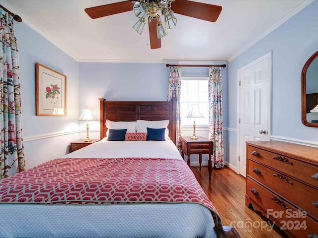 bedroom featuring ceiling fan, wood-type flooring, and ornamental molding