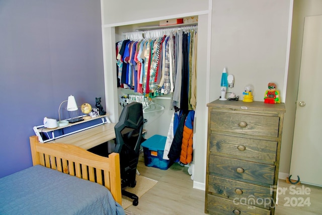 bedroom with light wood-type flooring and a closet