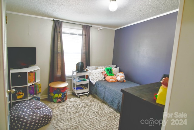 bedroom with multiple windows, crown molding, and a textured ceiling