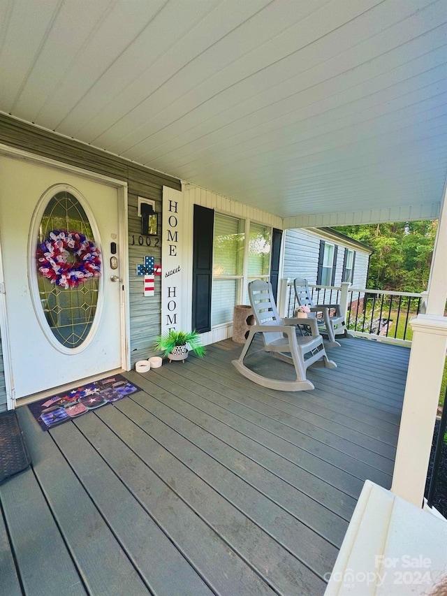 wooden terrace with a porch